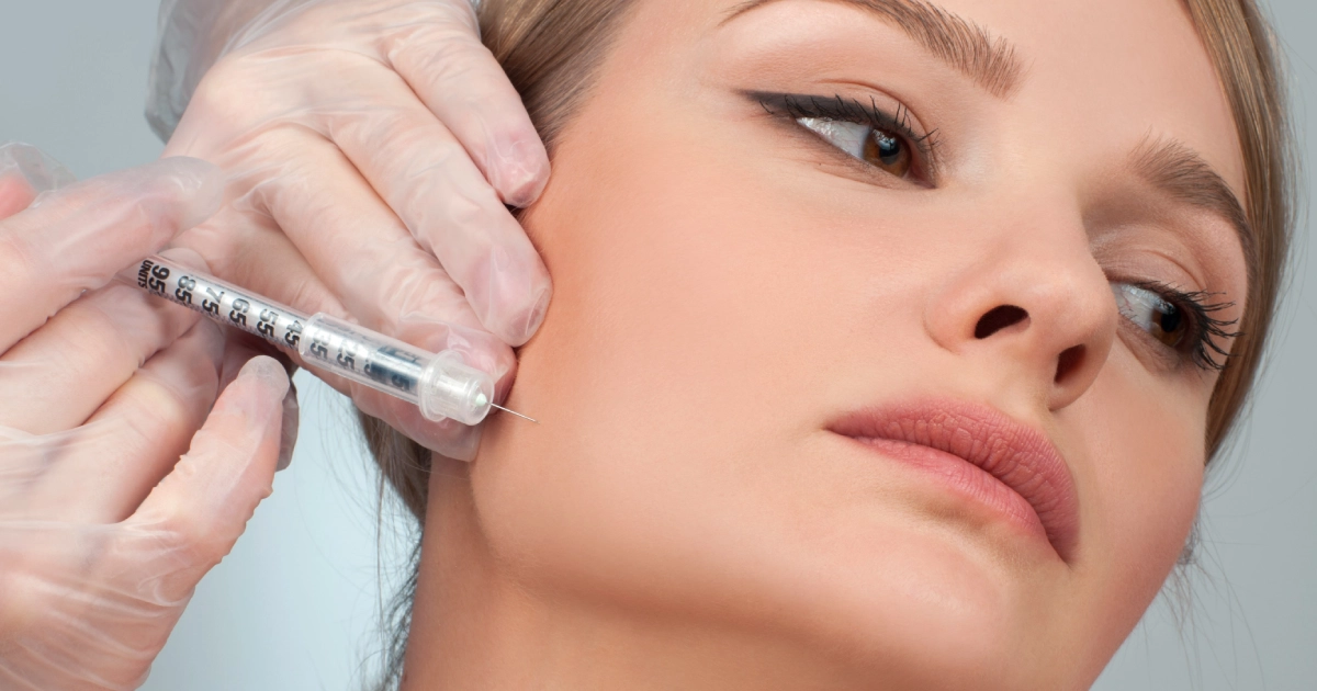 Young woman receiving Restylane Contour injection in cheek at Midland, TX clinic
